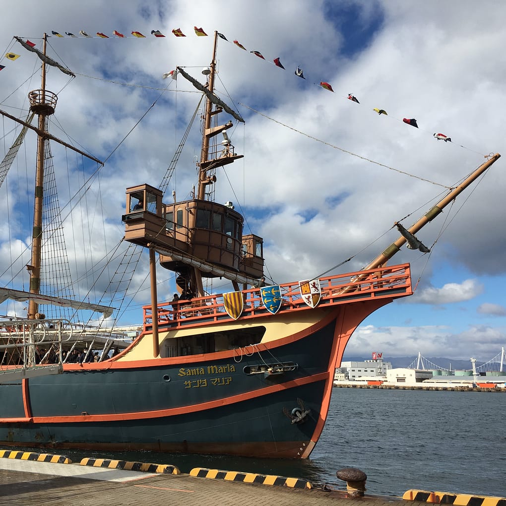 The Santa Maria cruise, painted blue, red and gold, docks and waits for passengers in Osaka bay