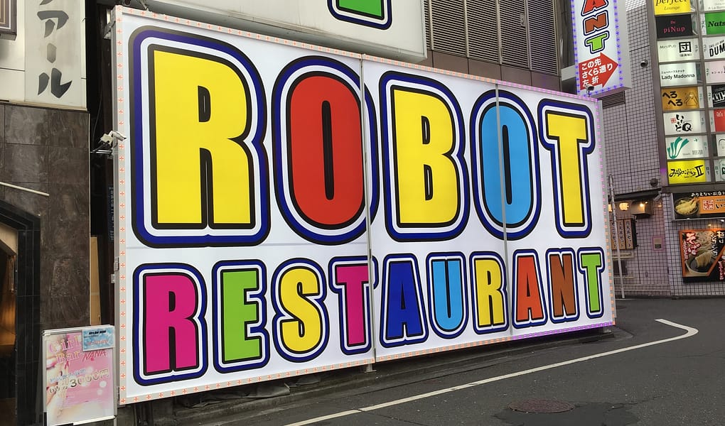 Colorful signage pointing the way to Robot Restaurant in Shinjuku