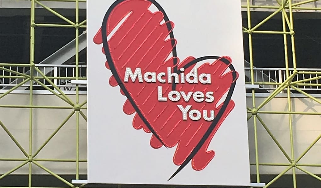 A public sign with a lopsided, hand drawn heart that reads "Machida Loves You"