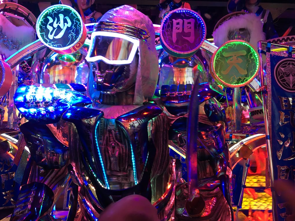 A shiny silver robot with neon sunglasses
