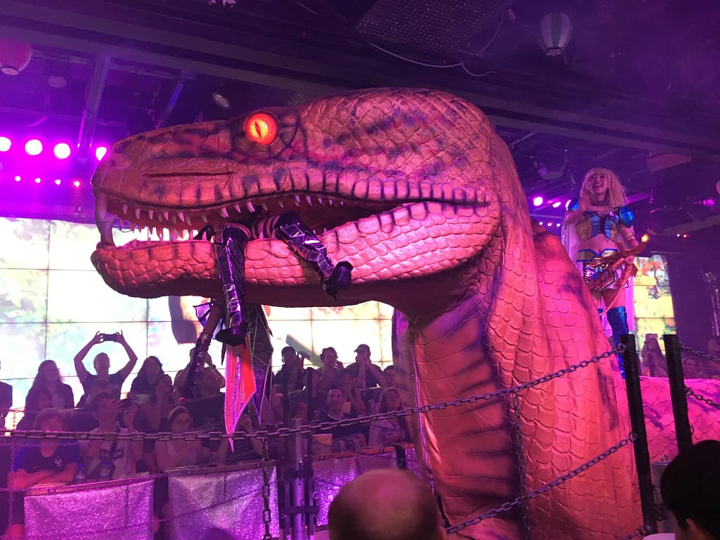 Animatronic snake holds a performer in its mouth