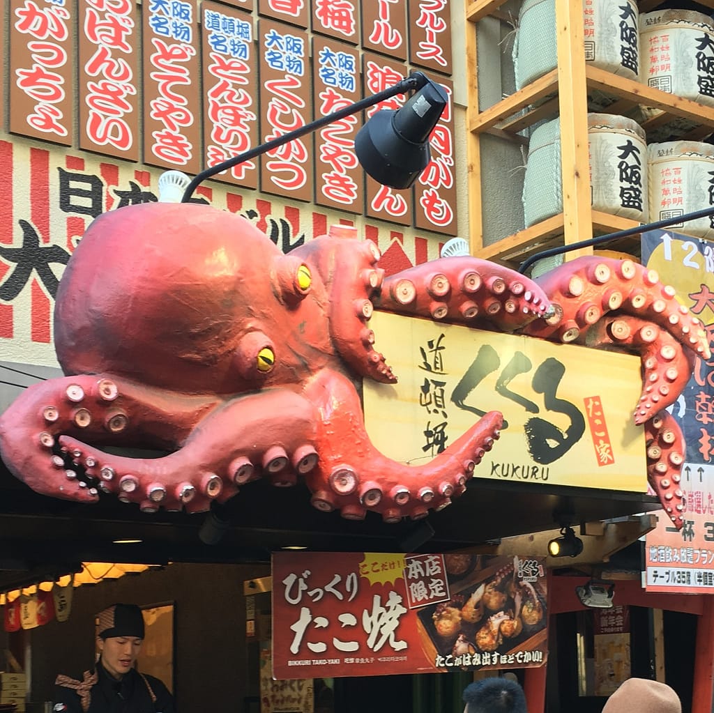 A giant octopus advertises takoyaki for sale on Dotonbori street in Osaka