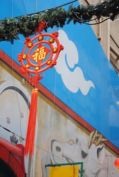A red decoration hangs from a wire above the streets in Chinatown