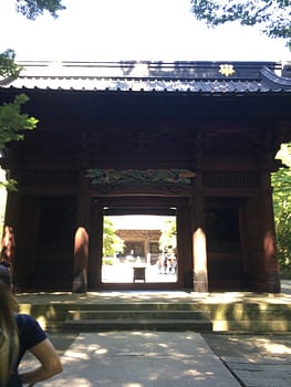 A wooden gate marks the entrance into the courtyard