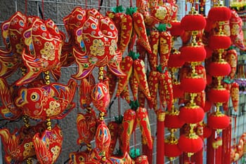 Plush red fish hang on display for sale in Chinatown