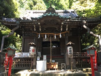 A highly decorated shrine surrounded by wooded area