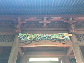 Colorful dragons guard the top of the gate entrance