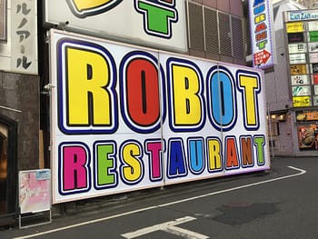 Colorful signage pointing the way to Robot Restaurant in Shinjuku