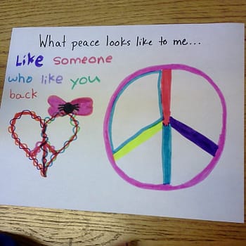 A student project on "what peace means to you." This student drew a piece sign within a heart shape and wrote "What peace looks like to you...like someone who likes you back"