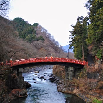 Red bridge over water in japan