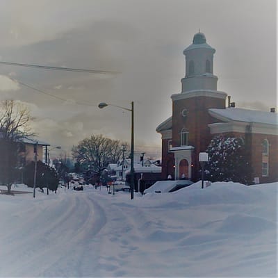 A church on a snowy street in winter