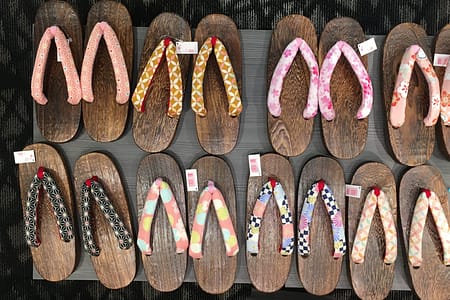 A variety of wooden geta shoes for sale, neatly arranged into rows.