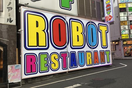 Colorful signage pointing the way to Robot Restaurant in Shinjuku