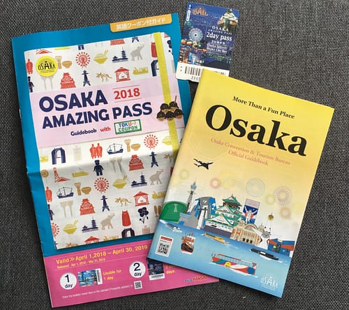 Two booklets and a paper pass card show the information received with the Osaka Amazing Pass