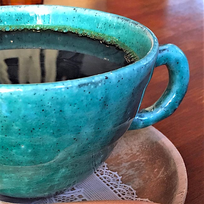 What I Learned Winter - teal hand made coffee mug on a wooden plate