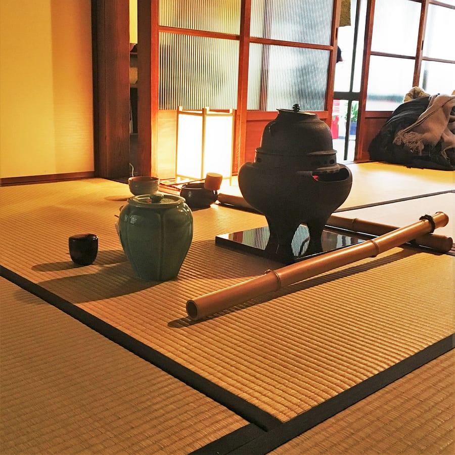 Implements for a traditional tea ceremony are laid out on a tatami mat